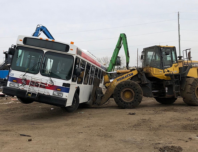 What’s Under the Crane? Buses on Their Way to a New Life